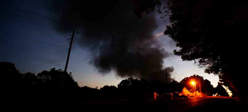“Light from a light pole shows a house near a plume of smoke from a Colonial Pipeline explosion, Monday, Oct. 31, 2016, in Helena, Ala. - AP”
